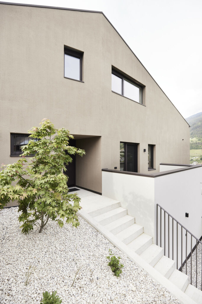 Moderner Hauseingang mit Treppe und Kiesbeet